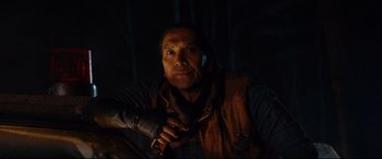 Movie still from “Blood Quantum” (2019), directed by Jeff Barnaby – A man with a cell phone in his hand; Close Up shot, Over the shoulder angle