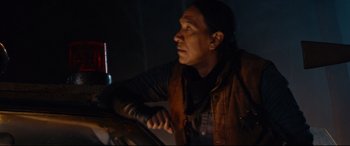 Movie still from “Blood Quantum” (2019), directed by Jeff Barnaby – A man sitting in a dark room looking up; Close Up shot, Low angle