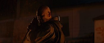 Movie still from “Blood Quantum” (2019), directed by Jeff Barnaby – A man with a knife in his mouth; Medium shot, Low angle