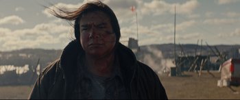 Movie still from “Blood Quantum” (2019), directed by Jeff Barnaby – A person wearing a jacket; Close Up shot, Over the shoulder angle