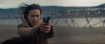Movie still from “Blood Quantum” (2019), directed by Jeff Barnaby – A woman is holding a gun in her hand; Close Up shot, Over the shoulder angle