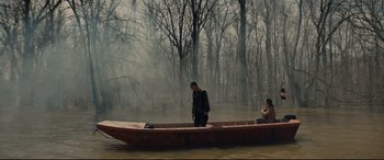 Movie still from “Blood Quantum” (2019), directed by Jeff Barnaby – A man and a woman in a boat on a body of water; Extreme Wide shot, High angle