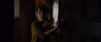 Movie still from “The Amazing Spider-Man” (2012), directed by Marc Webb – A young boy holding on to the handle of a door knob; Close Up shot, Over the shoulder angle