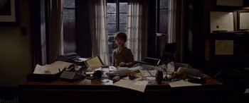 Movie still from “The Amazing Spider-Man” (2012), directed by Marc Webb – A young boy sitting at a desk in front of a window; Medium shot, High angle