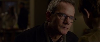 Movie still from “The Amazing Spider-Man” (2012), directed by Marc Webb – A person wearing glasses and a jacket; Close Up shot, Over the shoulder angle