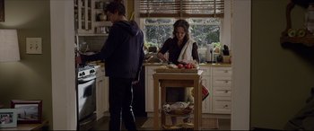 Movie still from “The Amazing Spider-Man” (2012), directed by Marc Webb – Two people in a kitchen preparing food on a table; Medium shot, Over the shoulder angle