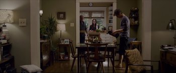 Movie still from “The Amazing Spider-Man” (2012), directed by Marc Webb – Two people standing at a dining room table in a house; Wide shot, Over the shoulder angle