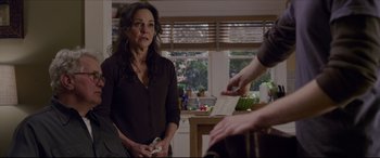 Movie still from “The Amazing Spider-Man” (2012), directed by Marc Webb – A woman standing next to a man in a kitchen; Medium shot, Over the shoulder angle