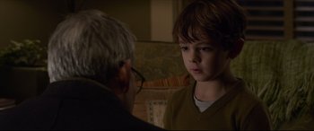 Movie still from “The Amazing Spider-Man” (2012), directed by Marc Webb – A young boy and an older man in a room; Close Up shot, Over the shoulder angle