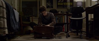 Movie still from “The Amazing Spider-Man” (2012), directed by Marc Webb – A man sitting on the ground with a briefcase; Wide shot, High angle