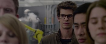 Movie still from “The Amazing Spider-Man” (2012), directed by Marc Webb – A person wearing glasses and a jacket; Close Up shot, Over the shoulder angle