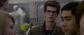 Movie still from “The Amazing Spider-Man” (2012), directed by Marc Webb – A person wearing glasses and a jacket; Close Up shot, Over the shoulder angle
