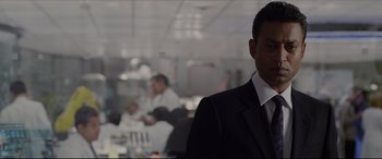 Movie still from “The Amazing Spider-Man” (2012), directed by Marc Webb – A man wearing a suit and tie standing in a room; Close Up shot, Over the shoulder angle