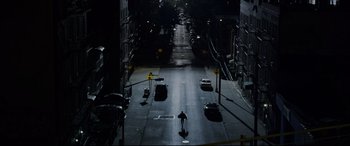 Movie still from “The Amazing Spider-Man” (2012), directed by Marc Webb – A person is walking down a street at night; Extreme Wide shot, High angle