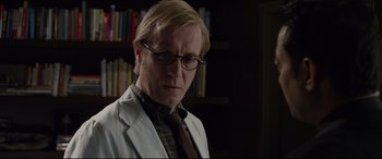 Movie still from “The Amazing Spider-Man” (2012), directed by Marc Webb – A man in a white lab coat and a brown neck tie; Close Up shot, Low angle