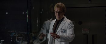 Movie still from “The Amazing Spider-Man” (2012), directed by Marc Webb – A man wearing a lab coat standing in front of a window; Medium shot, Low angle