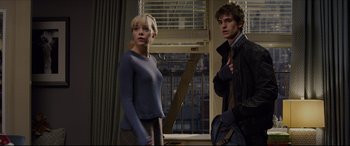 Movie still from “The Amazing Spider-Man” (2012), directed by Marc Webb – A man and a woman standing next to each other in front of a window; Medium shot, Over the shoulder angle