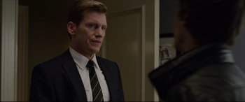 Movie still from “The Amazing Spider-Man” (2012), directed by Marc Webb – A person wearing a suit and tie; Close Up shot, Over the shoulder angle