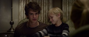 Movie still from “The Amazing Spider-Man” (2012), directed by Marc Webb – A young boy sitting next to a younger boy; Close Up shot, Over the shoulder angle