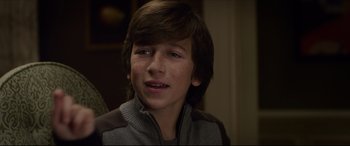 Movie still from “The Amazing Spider-Man” (2012), directed by Marc Webb – A young man with a brown hair and a brown jacket; Close Up shot, Over the shoulder angle