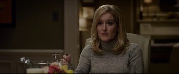 Movie still from “The Amazing Spider-Man” (2012), directed by Marc Webb – A woman sitting at a table with a glass of wine in front of her; Close Up shot, Over the shoulder angle