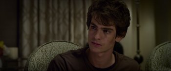 Movie still from “The Amazing Spider-Man” (2012), directed by Marc Webb – A young man sitting in a chair looking into the distance; Close Up shot, Over the shoulder angle