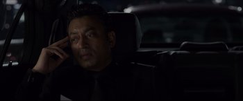 Movie still from “The Amazing Spider-Man” (2012), directed by Marc Webb – A man sitting in the back seat of a car at night; Close Up shot, Over the shoulder angle