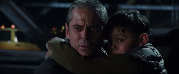 Movie still from “The Amazing Spider-Man” (2012), directed by Marc Webb – A man and a boy are hugging in a dark room; Close Up shot, Over the shoulder angle