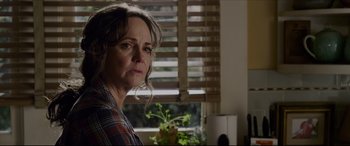 Movie still from “The Amazing Spider-Man” (2012), directed by Marc Webb – An older woman standing in front of a window; Close Up shot, Over the shoulder angle