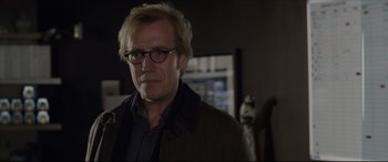 Movie still from “The Amazing Spider-Man” (2012), directed by Marc Webb – A person wearing glasses and a jacket; Close Up shot, Over the shoulder angle