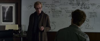 Movie still from “The Amazing Spider-Man” (2012), directed by Marc Webb – A man standing in front of a whiteboard holding a marker; Medium shot, Over the shoulder angle