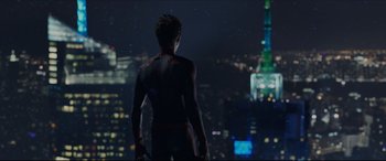 Movie still from “The Amazing Spider-Man” (2012), directed by Marc Webb – A man standing in front of a city at night; Wide shot, Over the shoulder angle