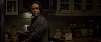 Movie still from “The Amazing Spider-Man” (2012), directed by Marc Webb – A woman standing in a kitchen next to a counter; Medium shot, Over the shoulder angle