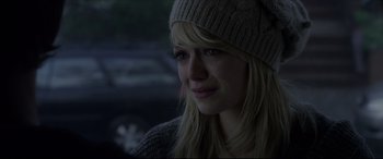 Movie still from “The Amazing Spider-Man” (2012), directed by Marc Webb – A woman wearing a hat and a sweater looks to her left; Close Up shot, Over the shoulder angle