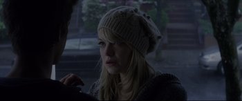 Movie still from “The Amazing Spider-Man” (2012), directed by Marc Webb – A woman wearing a hat sitting in a parking lot; Close Up shot, Over the shoulder angle