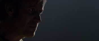 Movie still from “The Amazing Spider-Man” (2012), directed by Marc Webb – A man's face in the dark; Close Up shot, Low angle