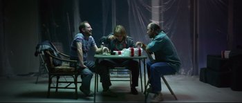 Movie still from “Blow” (2001), directed by Ted Demme – A group of people sitting around a table; Medium shot, Low angle