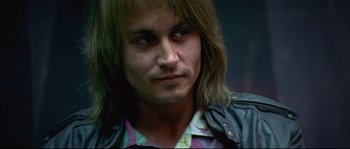 Movie still from “Blow” (2001), directed by Ted Demme – A person with long hair; Close Up shot, Low angle
