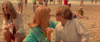 Movie still from “Blow” (2001), directed by Ted Demme – A man and a woman sitting on the beach; Medium shot, Low angle