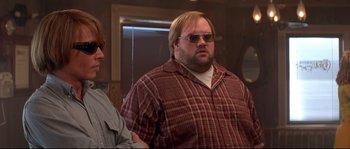 Movie still from “Blow” (2001), directed by Ted Demme – A man with blonde hair and a plaid shirt; Medium shot, Low angle