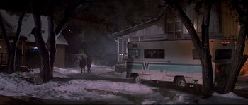 Movie still from “Blow” (2001), directed by Ted Demme – A couple of people standing in front of an rv; Wide shot, Low angle