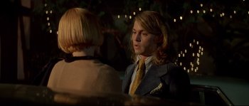 Movie still from “Blow” (2001), directed by Ted Demme – A man in a suit and a tie talking to a woman; Close Up shot, Over the shoulder angle
