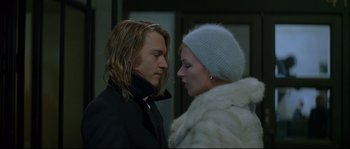 Movie still from “Blow” (2001), directed by Ted Demme – A man and a woman standing next to each other in front of a building; Close Up shot, Low angle