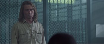 Movie still from “Blow” (2001), directed by Ted Demme – A man standing in front of a fence in front of a crowd; Close Up shot, Over the shoulder angle