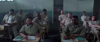 Movie still from “Blow” (2001), directed by Ted Demme – A group of men sitting in a room; Wide shot, High angle