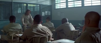 Movie still from “Blow” (2001), directed by Ted Demme – A group of men sitting at a table in front of a window; Wide shot, Over the shoulder angle