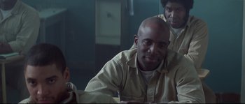 Movie still from “Blow” (2001), directed by Ted Demme – A man sitting at a table in front of a mirror; Close Up shot, Over the shoulder angle