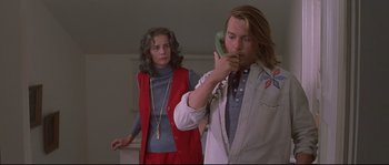 Movie still from “Blow” (2001), directed by Ted Demme – A man and a woman standing next to each other; Medium shot, Low angle