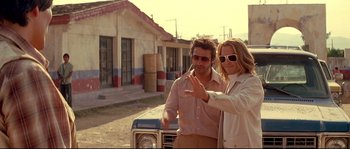 Movie still from “Blow” (2001), directed by Ted Demme – A man and a woman standing in front of a car; Medium shot, Low angle