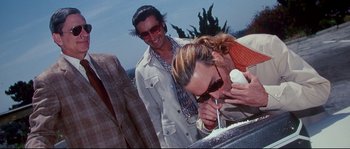 Movie still from “Blow” (2001), directed by Ted Demme – A man and a woman are eating cake; Medium shot, High angle